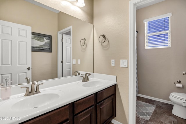 bathroom with toilet and vanity