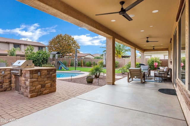 view of patio with ceiling fan, a playground, and area for grilling