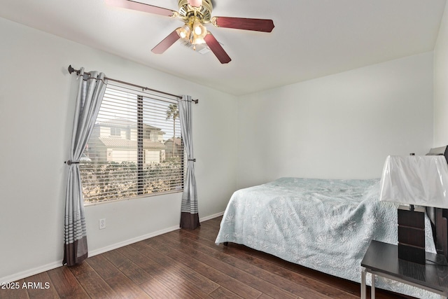 bedroom with dark hardwood / wood-style floors and ceiling fan