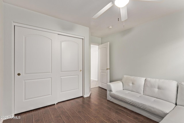 sitting room with ceiling fan and dark hardwood / wood-style floors