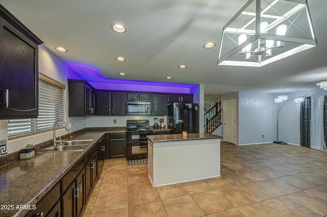 kitchen featuring black appliances, a center island, a sink, and recessed lighting