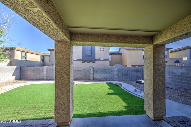 view of yard with a patio area and a fenced backyard