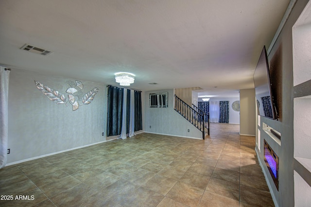 interior space featuring stairway, visible vents, and baseboards