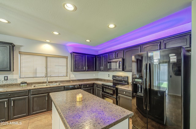 kitchen featuring recessed lighting, light tile patterned floors, a sink, a center island, and black appliances