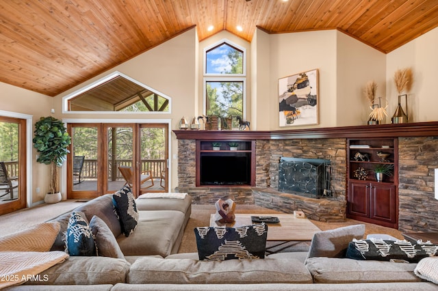 1018 N Amberwood St, Flagstaff, AZ 86004 - living area featuring carpet floors, vaulted ceiling, wooden ceiling, and a stone fireplace