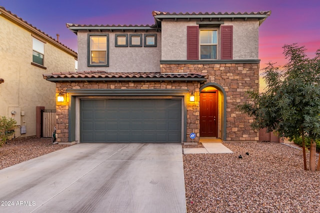 mediterranean / spanish-style home with a garage