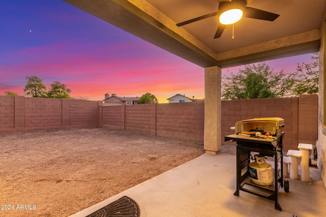 patio terrace at dusk featuring ceiling fan