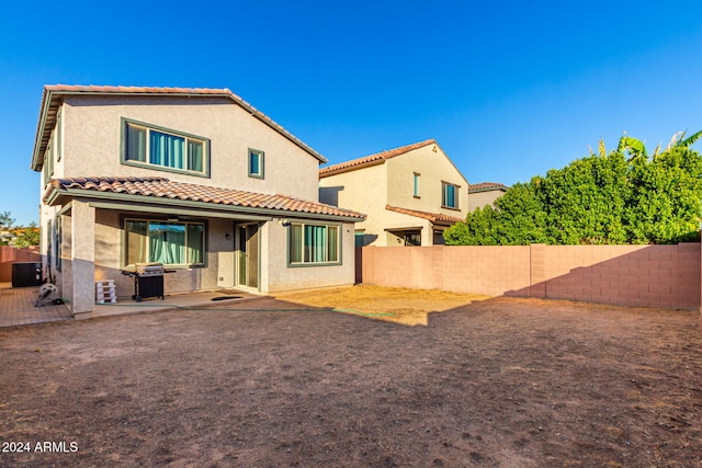 rear view of property with a patio area