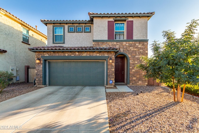 mediterranean / spanish-style home with a garage