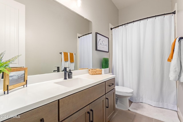 bathroom featuring vanity, tile patterned floors, and toilet