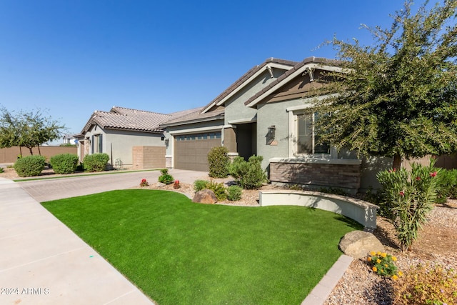 view of front of house with a garage and a front lawn