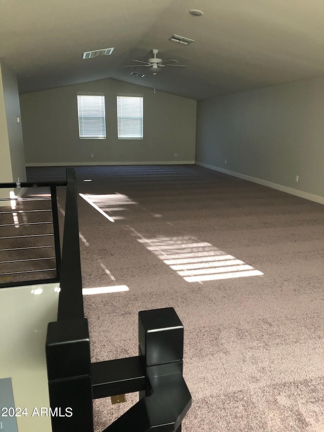 unfurnished room with ceiling fan, carpet flooring, and vaulted ceiling