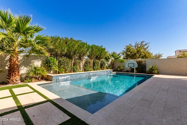 view of swimming pool with pool water feature and a patio