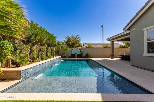 view of swimming pool with a patio area and pool water feature