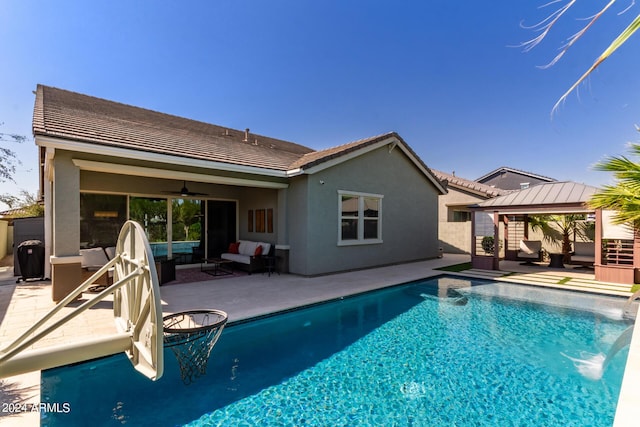 view of swimming pool featuring ceiling fan, a gazebo, an outdoor living space, and a patio