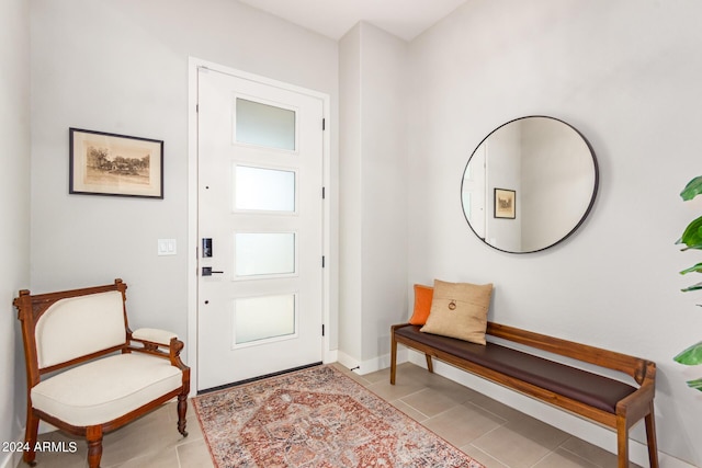 foyer entrance with light tile patterned flooring