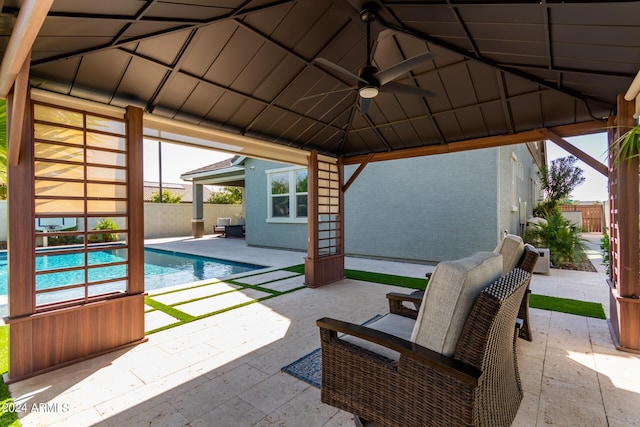 view of pool with ceiling fan and a patio area