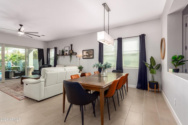 dining space featuring ceiling fan and light tile patterned floors