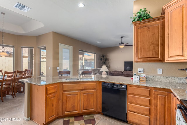 kitchen with light stone counters, black appliances, sink, and plenty of natural light