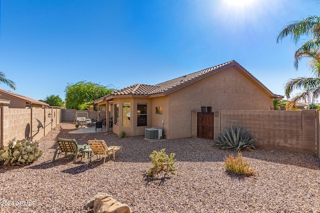 rear view of house featuring a patio and central AC unit