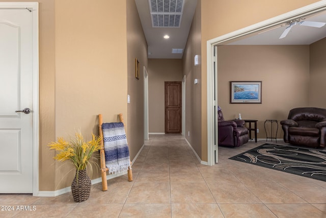 hall featuring light tile patterned floors