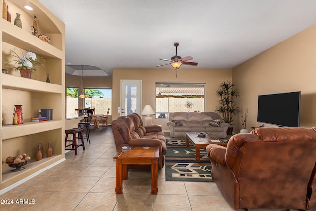 living room with ceiling fan and light tile patterned floors