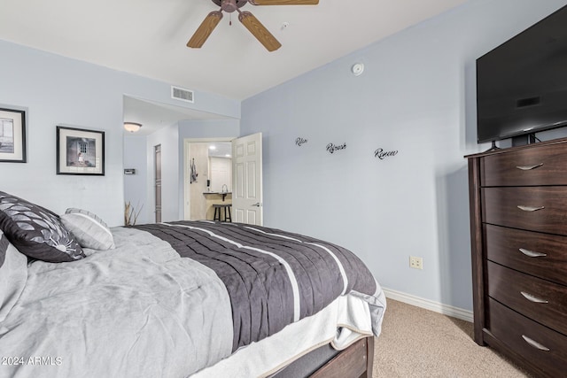 bedroom with baseboards, a ceiling fan, visible vents, and light colored carpet