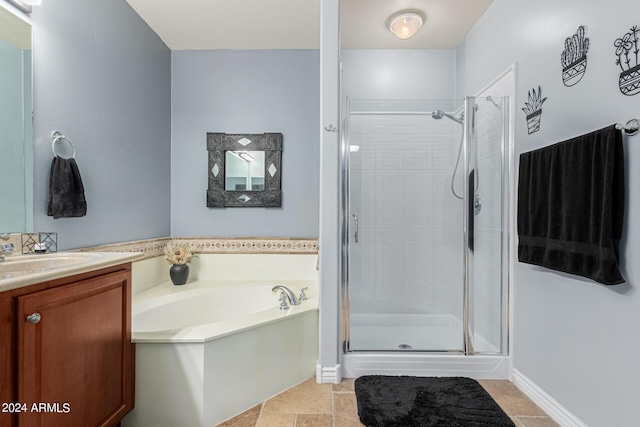 bathroom featuring a stall shower, vanity, baseboards, and a bath