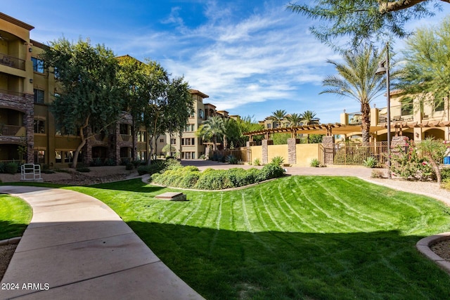 view of home's community featuring a lawn, fence, and a residential view