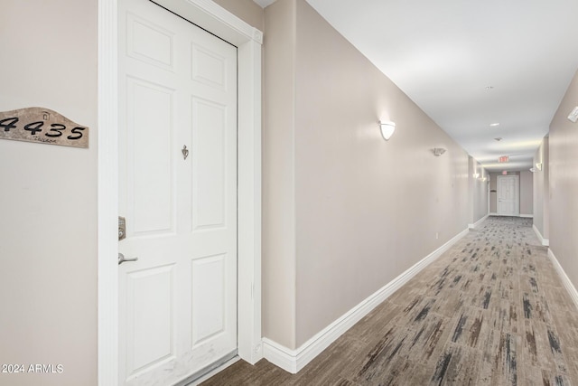 hallway with baseboards and wood finished floors