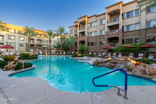 community pool with a patio and fence