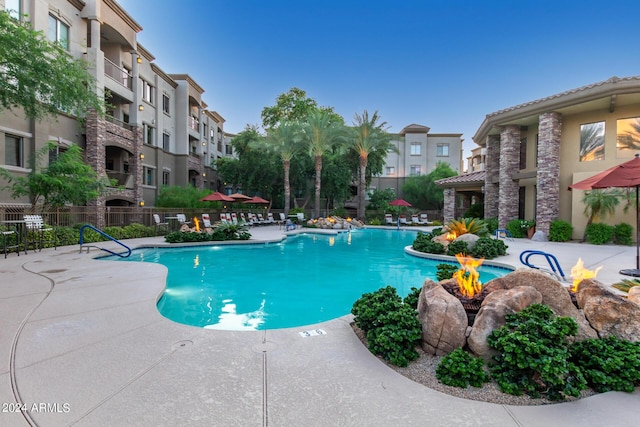 pool with a patio area, a residential view, and fence