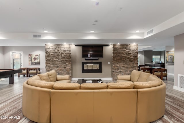 living area with wood finished floors, visible vents, and recessed lighting