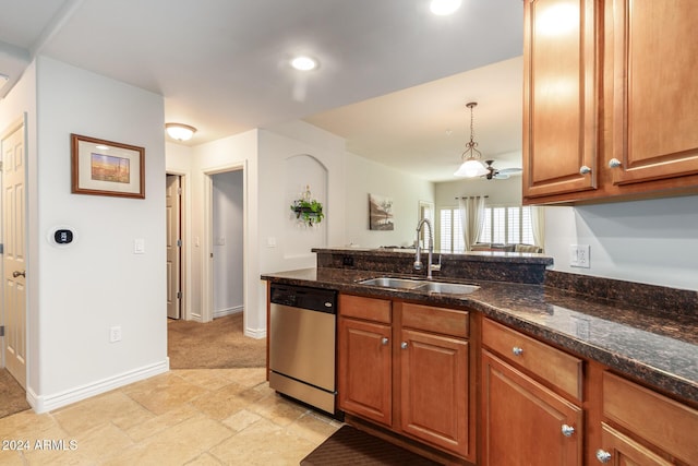 kitchen with dishwasher, pendant lighting, dark stone counters, and a sink