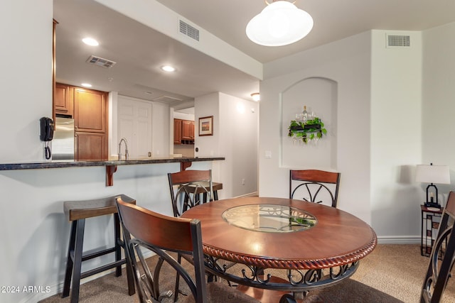 dining room with recessed lighting, visible vents, and light carpet