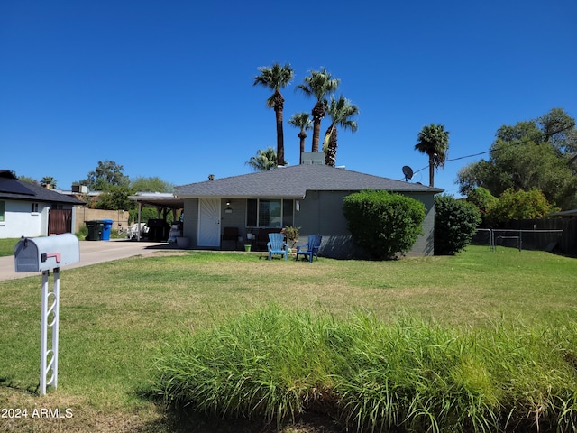 view of front of property with a carport and a front yard