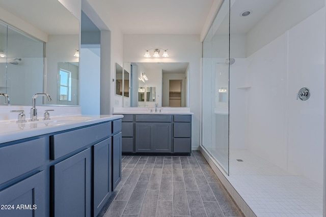 bathroom featuring a shower, vanity, and wood-type flooring