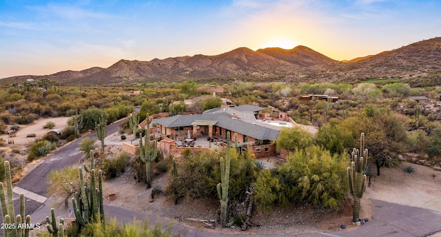 aerial view at dusk featuring a mountain view