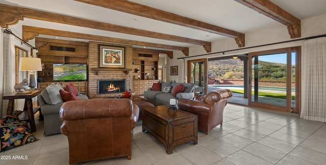 living room with beam ceiling, a fireplace, and light tile patterned floors