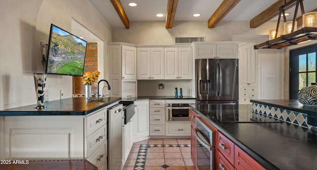 kitchen featuring light tile patterned floors, stainless steel appliances, dark countertops, and visible vents