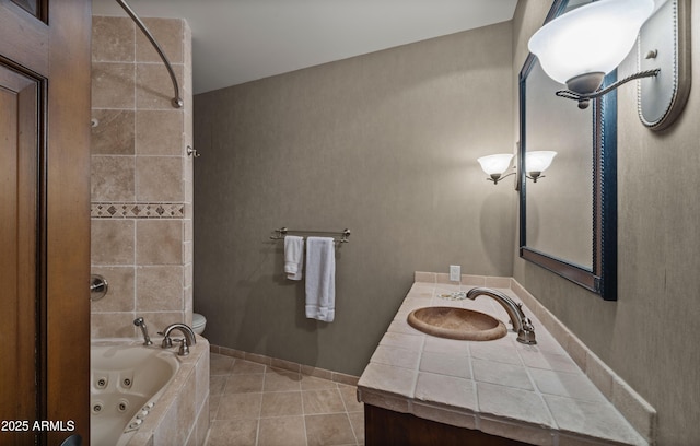 full bath featuring tile patterned flooring, a combined bath / shower with jetted tub, vanity, and baseboards