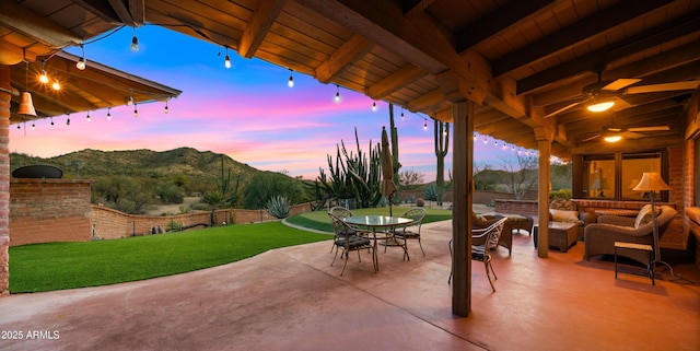 view of patio / terrace featuring a mountain view, outdoor dining space, and an outdoor living space