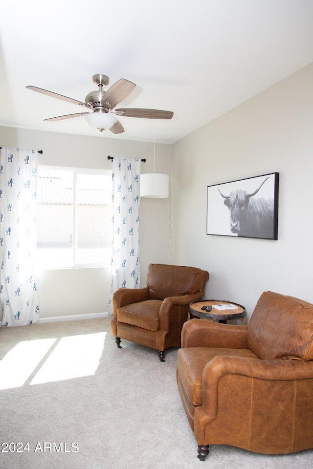 living room with ceiling fan and carpet