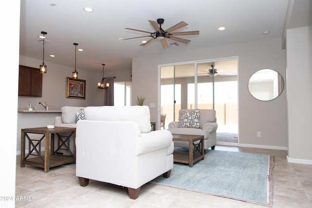 living room with recessed lighting, visible vents, baseboards, and ceiling fan with notable chandelier