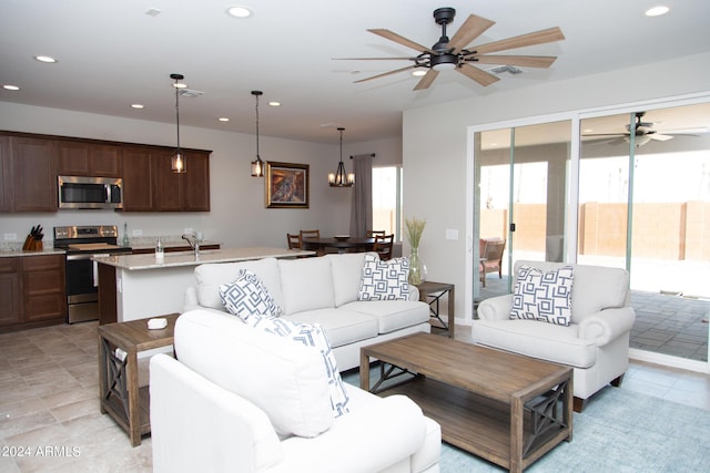 living room featuring visible vents, a ceiling fan, and recessed lighting