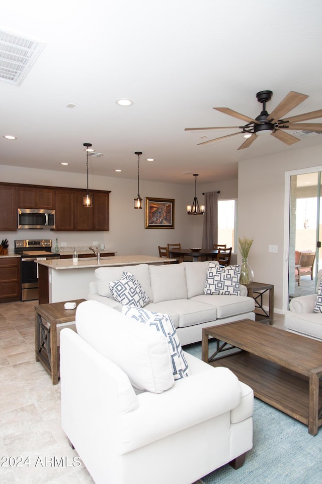 living area featuring ceiling fan, visible vents, and recessed lighting