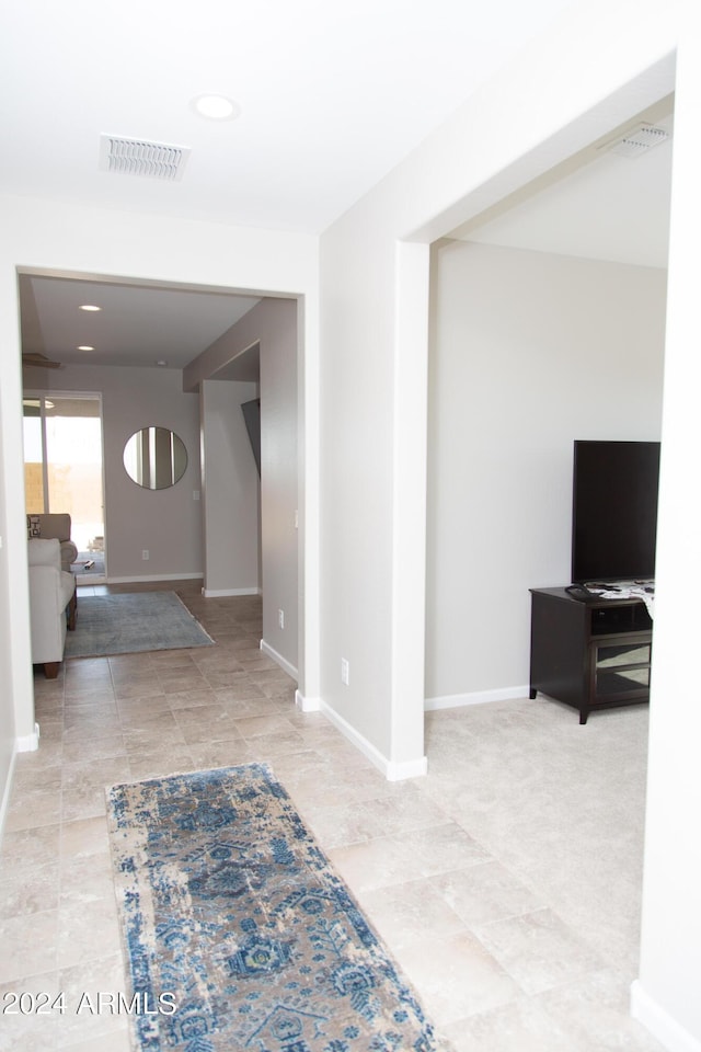 foyer entrance with baseboards and visible vents