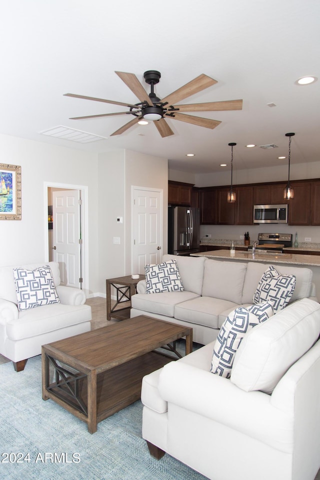 living area with visible vents, a ceiling fan, and recessed lighting