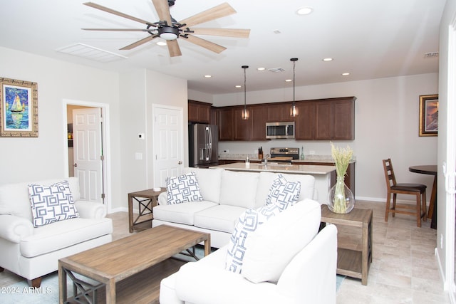 living area with recessed lighting, visible vents, ceiling fan, and baseboards