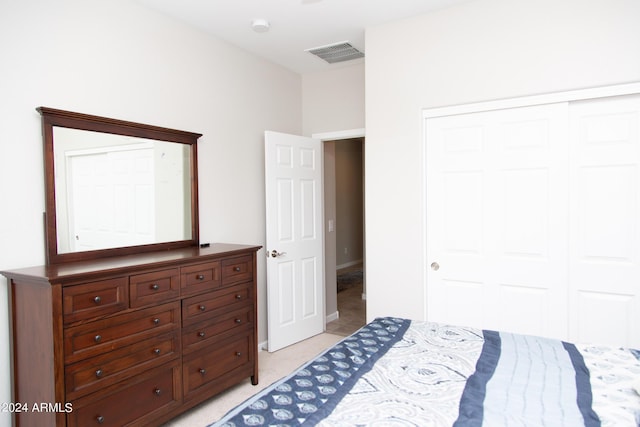 bedroom featuring light carpet, a closet, and visible vents